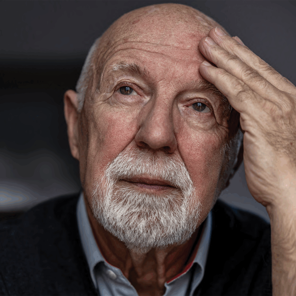 A senior man appearing thoughtful and concerned, illustrating the emotional and cognitive impact of untreated hearing loss