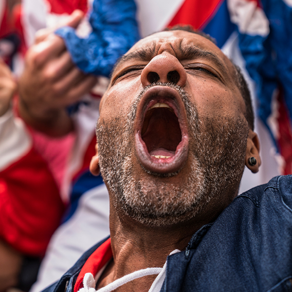 A man cheering and yelling at a sporting event.